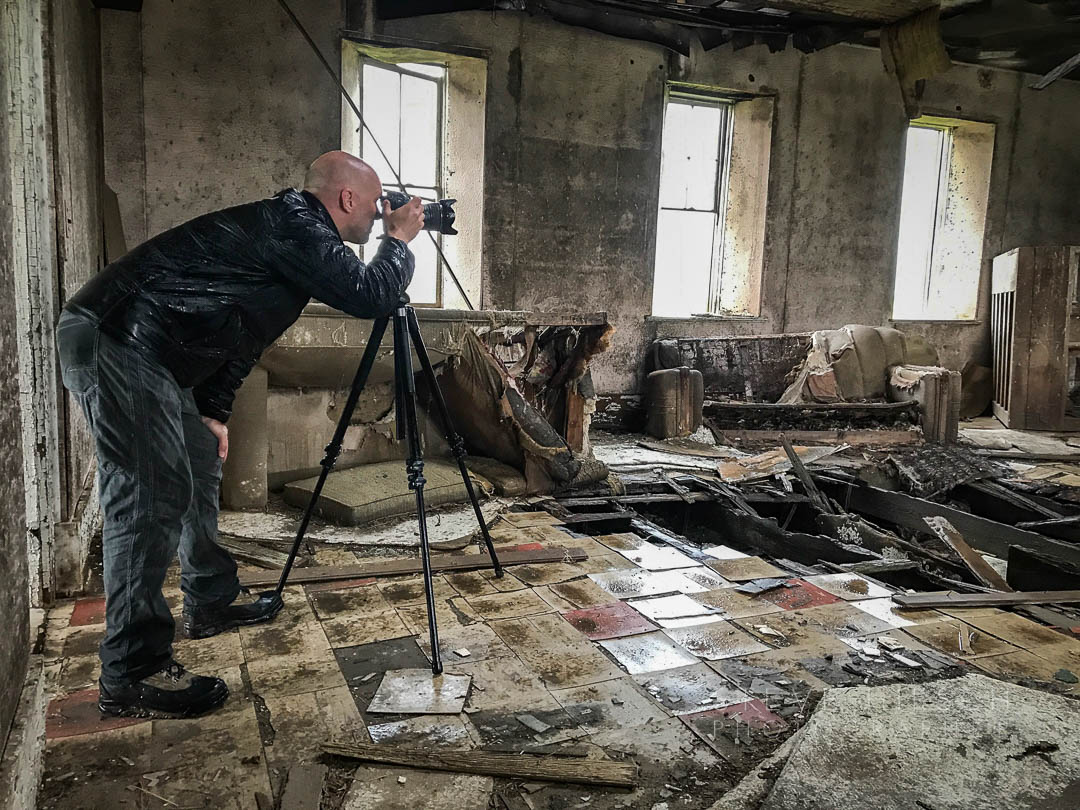 Steve Hirsch photographing the interior of an abandoned church in Kansas during a rainy day.