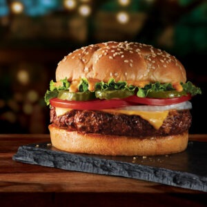 Front-of-pack photo of the Gardein Ultimate Burger featuring a sesame seed bun, plant-based patty, lettuce, pickles, tomato, and cheese, photographed by CPG food photographer Steve Hirsch.
