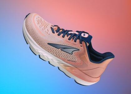 Altra Provision 6 women’s running shoe in dusty pink with navy blue accents, photographed by Steve Hirsch against a dynamic gradient background.
